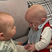 Twins joined the competition — help win amazing prizes! baby, infant, couch, pillow, nasal_tube, face, hand, clothing, sitting, interaction, cute, child, indoor, plaid, pattern, person, toddler, holding_hands, medical_tape, home