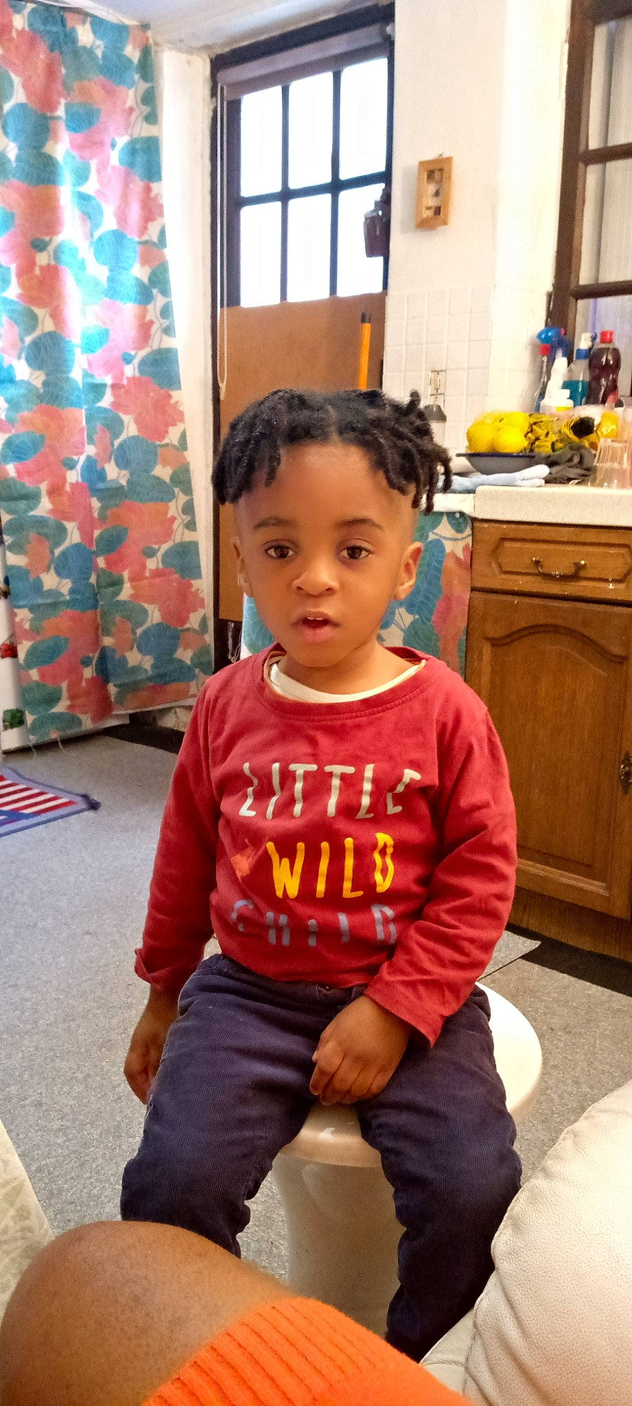 Kemuel a rejoint le concours — aidez-le/la à gagner de superbes lots ! baby_toddler_clothing, cabinetry, child, curtain, drawer, flooring, fun, happy, leisure, orange, people, person, photograph, red, sleeve, snapshot, standing, t_shirt, toddler, wood