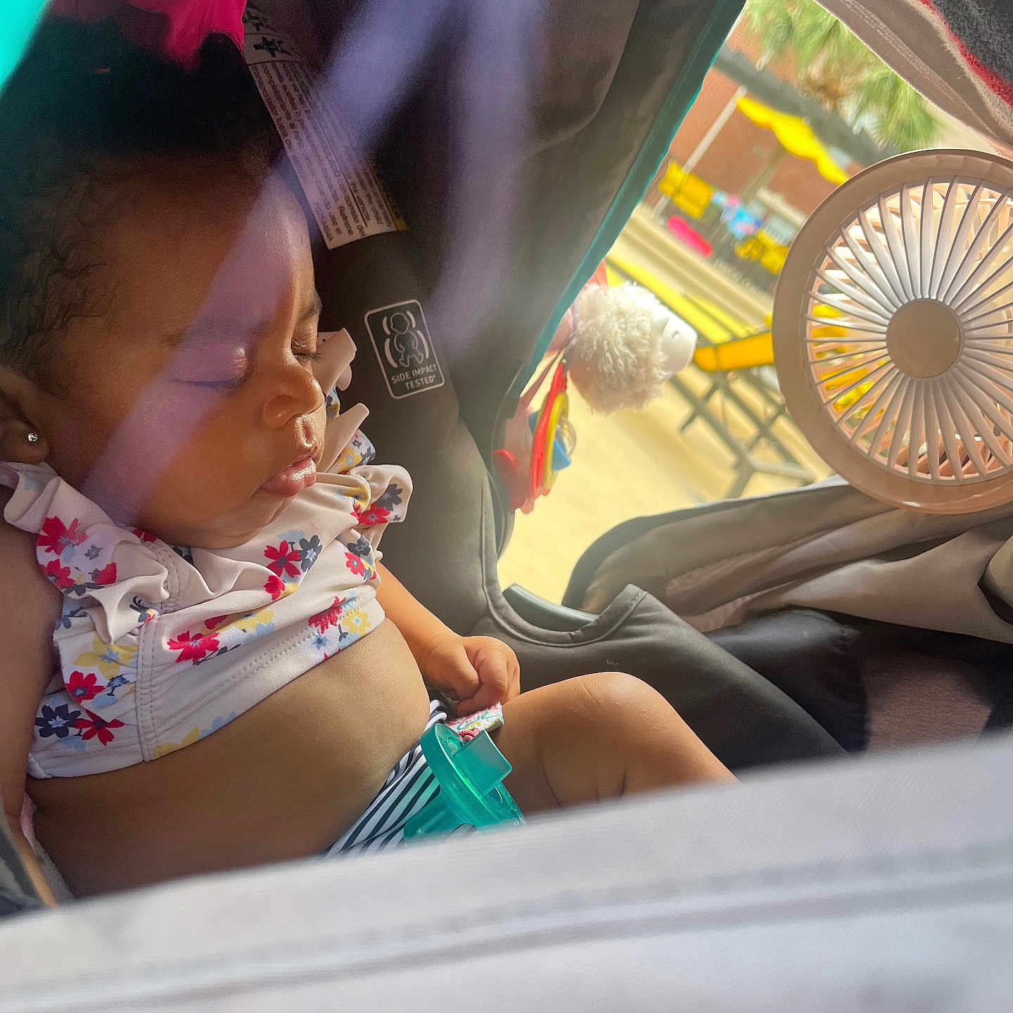 Gregory is registered to the contest to win money with this photo: baby, child, closeup, clothing, colorful, cute, fan, infant, outdoor, pacifier, peaceful, portrait, relaxation, resting, seat, sleeping, stroller, summer, sunlight, toy