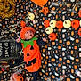 baby, black, blanket, candy, celebration, cute, decorations, face, festive, floor, halloween, holiday, holiday_decoration, infant, orange, pumpkin_costume, seasonal, smiling, toy, white