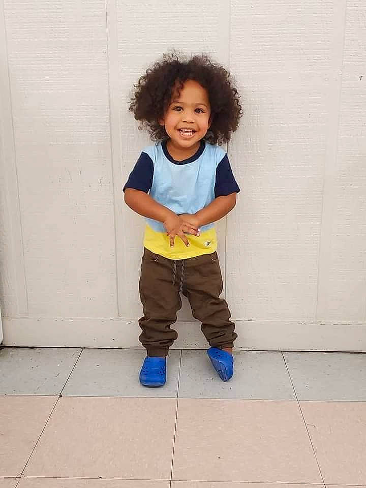 Seven is registered to the contest to win money with this photo: arm, baby_toddler_clothing, cheek, denim, eye, face, flooring, gesture, hair, hand, happy, head, human_body, joy, knee, leg, outerwear, person, sleeve, smile