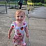Samantha is registered to the contest to win money with this photo: toddler, child, girl, blue_eyes, pink_crocs, strawberry_dress, concrete, outdoor, woman, phone, sunglasses, green_shirt, yellow_bench, fence, wet_ground, park, sidewalk, casual, daytime, smile