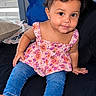 Amelia is registered to the contest to win money with this photo: toddler, child, sitting, portrait, smiling, indoors, bedroom, bed, floral_top, pink_clothing, jeans, curly_hair, barefoot, window, blinds, pillows, home, happy, person, photography