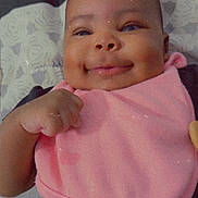 Faith joined the competition — help win amazing prizes! baby, infant, child, smiling, portrait, lying_down, pink_clothing, blanket, bed, bedding, indoor, face, eyes, nose, mouth, hand, arm, happy, close_up, flower_sticker