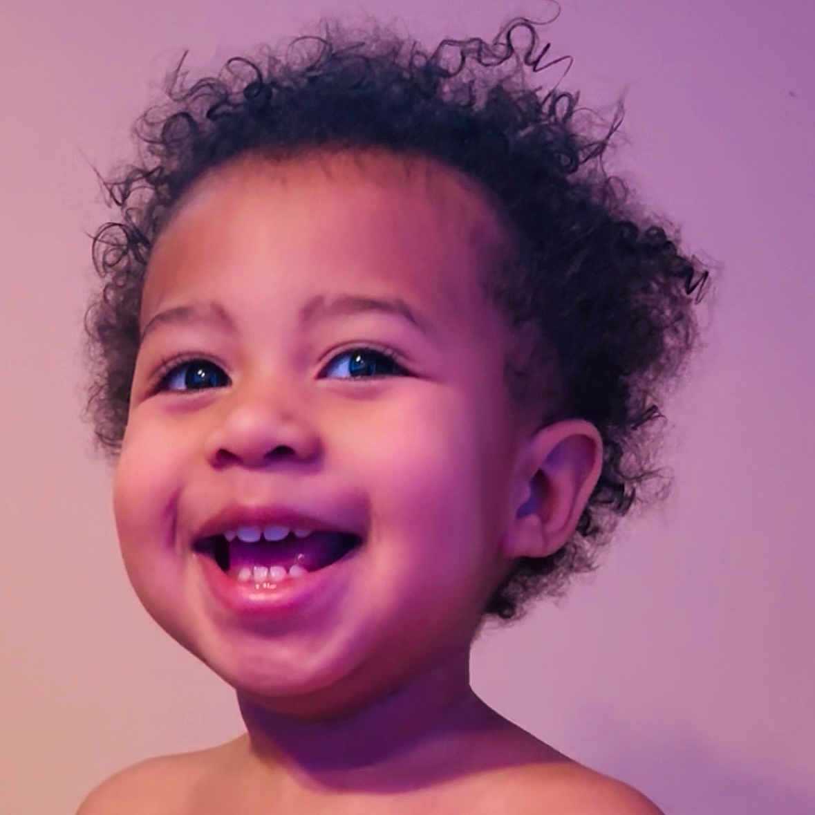 Trayce Daniel joined the competition — help win amazing prizes! child, toddler, smiling, curly_hair, portrait, happy, face, bare_shoulders, cute, innocence, young_child, glowing_skin, blue_eyes, head_and_shoulders, studio_lighting, purple_background, joyful, expressive, close_up, human