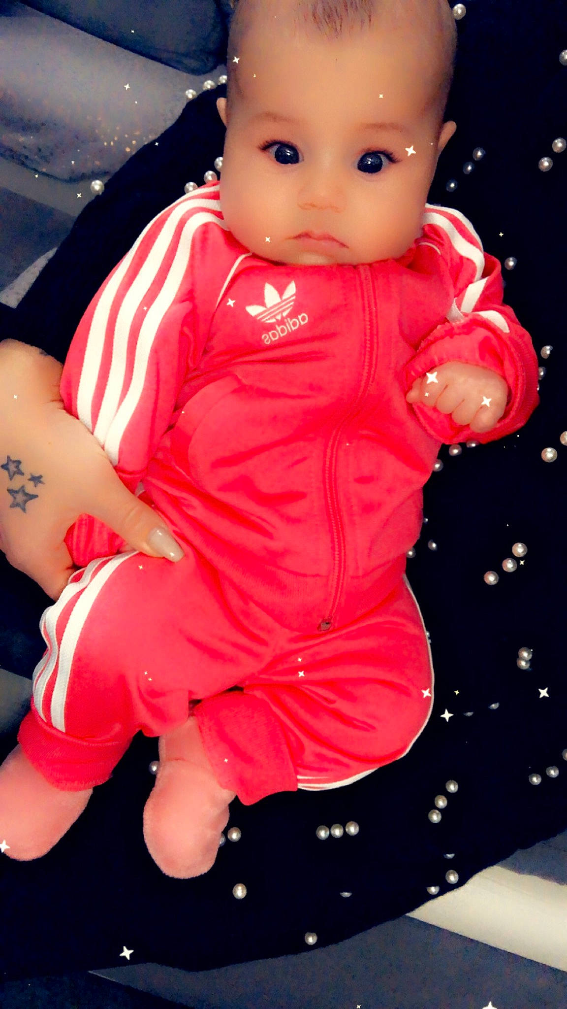 Zeyna a rejoint le concours — aidez-le/la à gagner de superbes lots ! baby, baby_products, baby_toddler_clothing, baby_toys, cheek, doll, overall, person, sock, toy