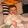 Léon Grange a rejoint le concours — aidez-le/la à gagner de superbes lots ! child, toddler, smiling, couch, pillow, blanket, clothing, cozy, indoors, happy, face, person, home, relaxing, sitting, cute, warm, comfort, baby, portrait