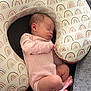 Ellanor Rose is registered to the contest to win money with this photo: newborn, baby, sleeping, infant, pink_onesie, rainbow_pattern, nursing_pillow, couch, cozy, peaceful, resting, soft_fabric, child, indoors, cute, tiny_feet, portrait, closeup, comfort, relaxation