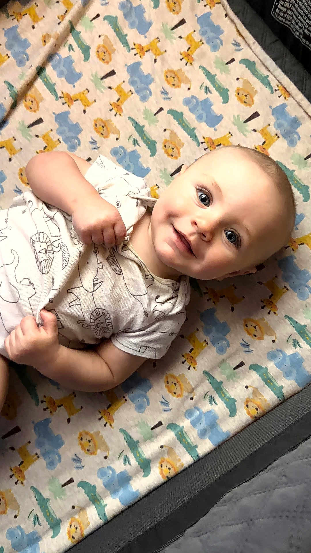 Wilder joined the competition — help win amazing prizes! baby, child, infant, smiling, blanket, animal_print, giraffe, elephant, lion, crocodile, cute, happy, lying_down, clothing, person, portrait, indoors, playpen, soft_texture, toddler