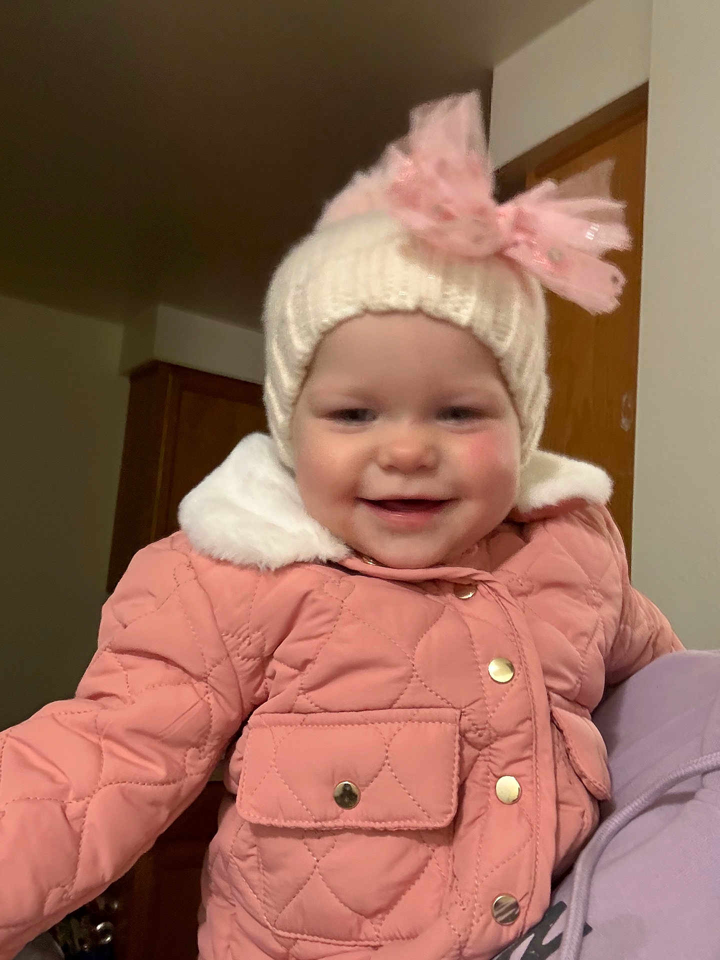Ilah Jo joined the competition — help win amazing prizes! toddler, child, smiling, pink_jacket, knit_hat, bow, indoor, portrait, warm_clothing, cute, happy, baby, face, person, apparel, closeup, childhood, winter_wear, fashion, young