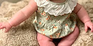 Renley is registered to the contest to win money with this photo: baby, blanket, child, closeup, cute, feet, floral_dress, hands, happy, head_wrap, indoors, infant, letters, numbers, portrait, sitting, skin, smiling, soft_texture, wooden_blocks
