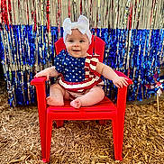 Renley joined the competition — help win amazing prizes! baby, child, red_chair, headband, white_bow, patriotic_outfit, stars_and_stripes, smiling, festive_background, streamers, red, blue, silver, wood_chips, outdoor, happy, sitting, cute, portrait, person