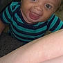 baby, child, smiling, curly_hair, striped_shirt, blue_shirt, green_shirt, face, eyes, mouth, tongue, arm, skin, indoor, candid, closeup, happy, person, infant, portrait