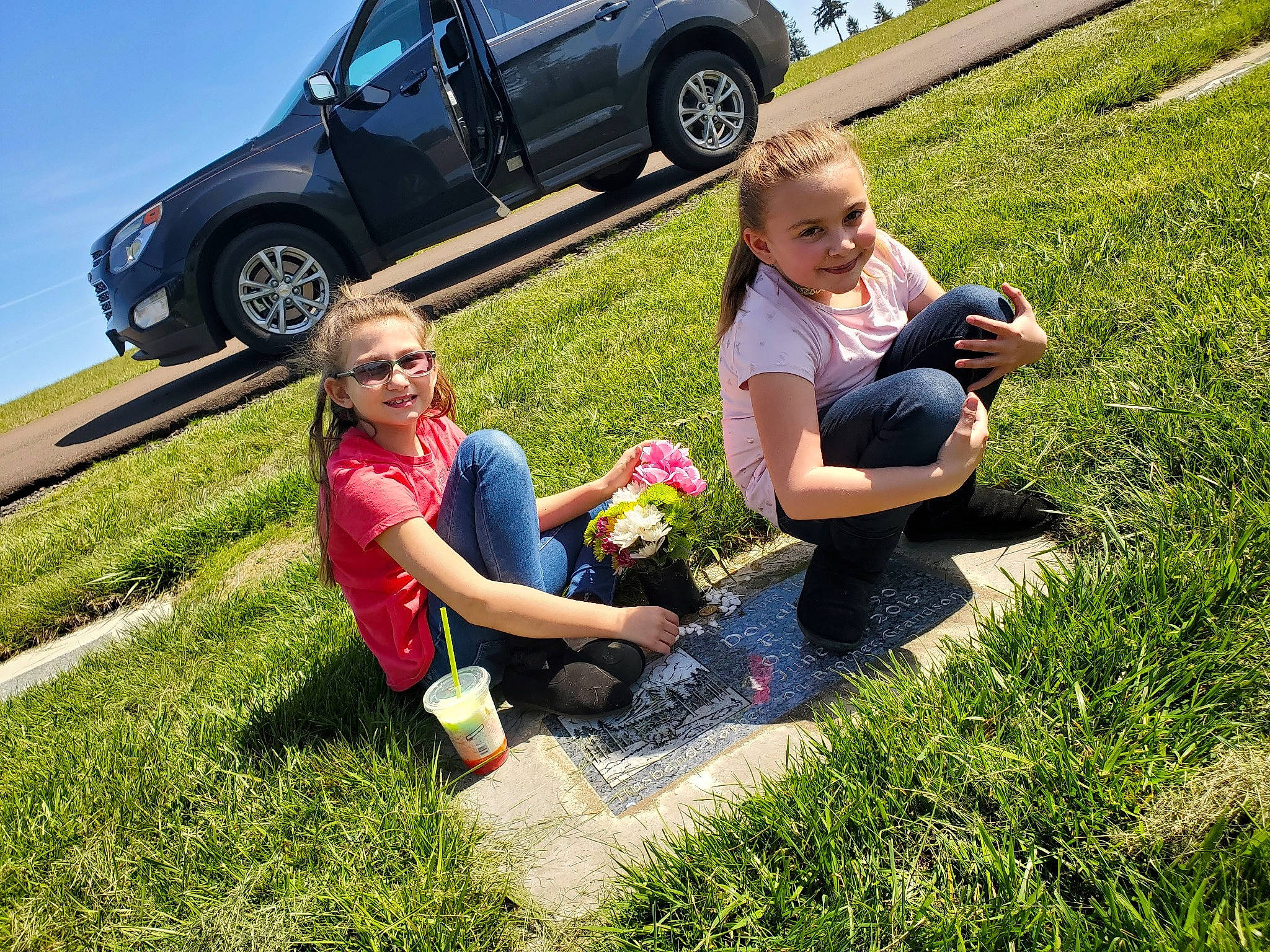 Chloe is registered to the contest to win money with this photo: alloy_wheel, automotive_design, automotive_exterior, automotive_tire, bumper, car, grass, joy, landscape, leisure, light, morning, motor_vehicle, people_in_nature, person, plant, shorts, sunglasses, tire, vehicle