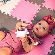 Everleigh joined the competition — help win amazing prizes! baby, child, toy, headband, pink, purple, foam_mats, floor, indoor, playtime, cute, infant, girl, clothing, hand, expression, blue_eyes, pacifier, colorful, soft_toys