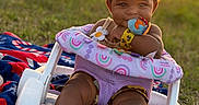 Leyah is registered to the contest to win money with this photo: baby, baby_seat, blanket, bow, child, cute, grass, hand, happy, infant, nature, outdoor, playful, portrait, sitting, smile, sunlight, sunset, toy, warm_light