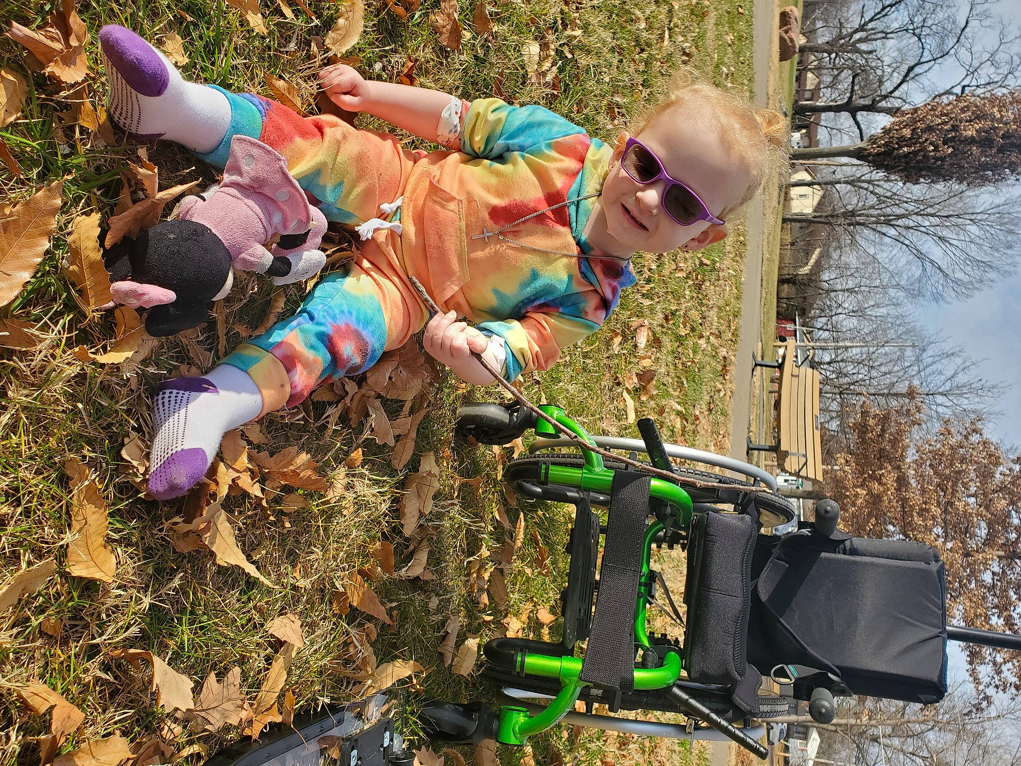 Amber is registered to the contest to win money with this photo: bicycle_handlebar, eyewear, fun, grass, joy, jungle, leisure, machine, people_in_nature, person, personal_protective_equipment, plant, recreation, shorts, sky, soil, sunglasses, t_shirt, tire, toddler