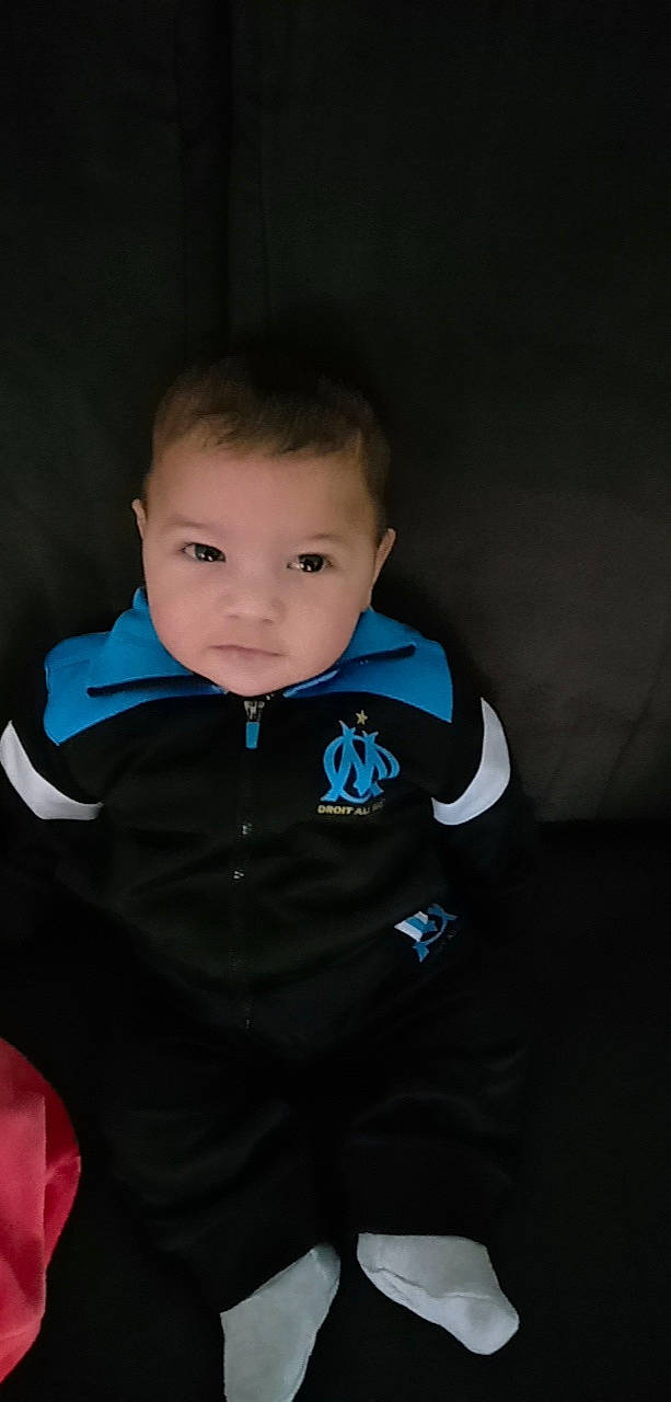 Mike participe au concours pour gagner de l'argent avec cette photo : baby, baby_toddler_clothing, cheek, child, comfort, darkness, electric_blue, eye, eyebrow, flash_photography, formal_wear, fun, hoodie, iris, jacket, person, personal_protective_equipment, sitting, sleeve, t_shirt