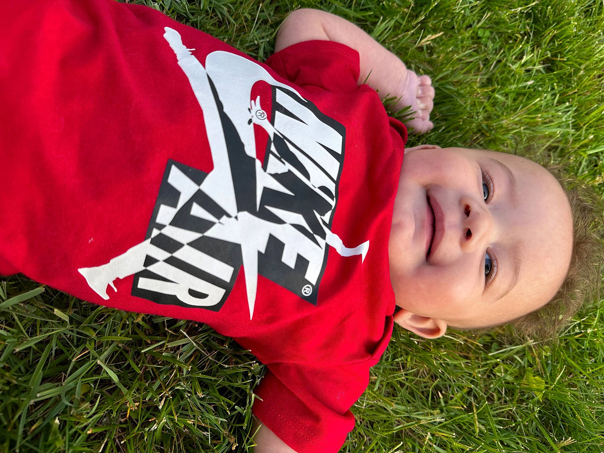 Drayden is registered to the contest to win money with this photo: baby, carmine, child, event, fun, grass, grassland, happy, hat, lawn, leisure, pattern, people_in_nature, person, plant, prairie, recreation, smile, t_shirt, toddler