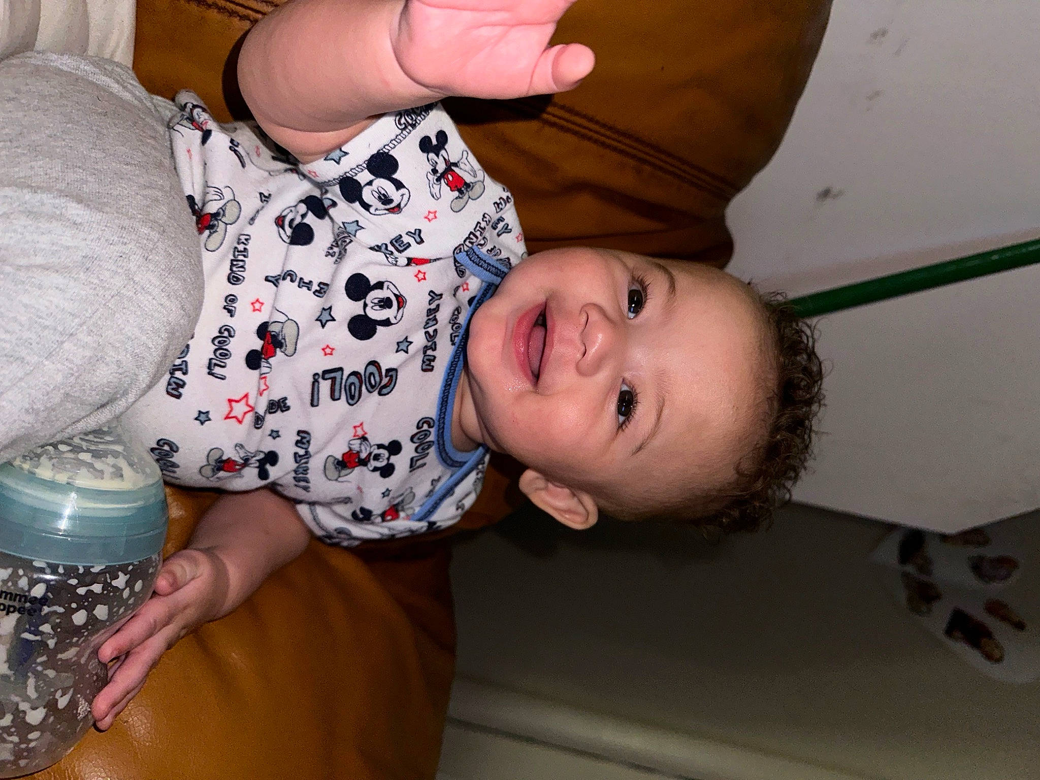 Drayden is registered to the contest to win money with this photo: arm, baby, baby_toddler_clothing, cheek, child, comfort, elbow, finger, gesture, happy, mouth, nose, organ, pattern, person, plastic_bottle, skin, sleeve, smile, t_shirt