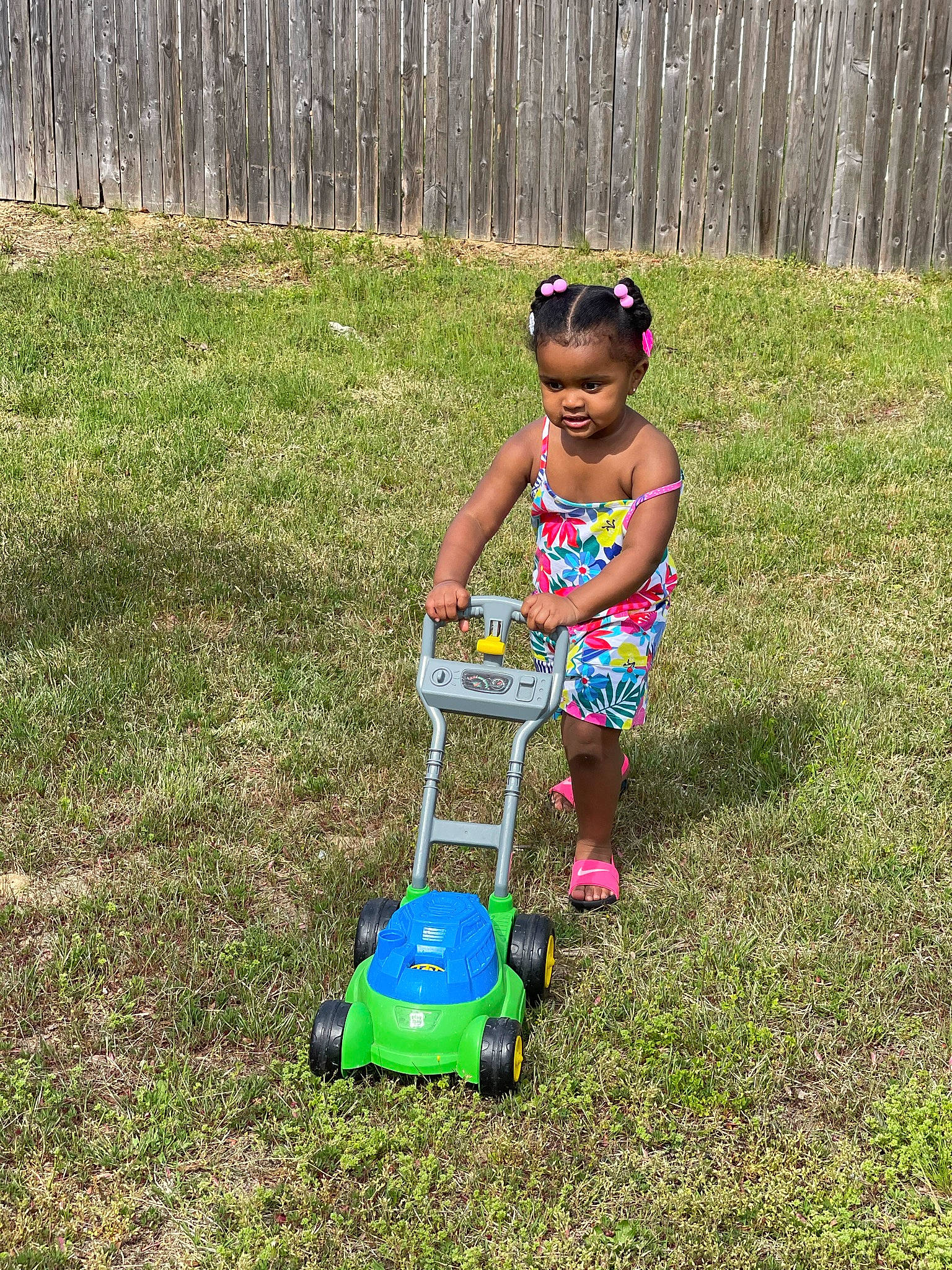 Rylynn is registered to the contest to win money with this photo: baby, baby_toddler_clothing, child, fun, grass, grass_family, grassland, happy, lawn, leisure, mower, people_in_nature, person, plant, recreation, smile, sunglasses, tire, toddler, tree
