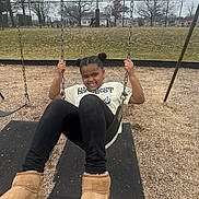 Rylynn joined the competition — help win amazing prizes! child, swing, playground, boots, grass, trees, fence, basketball_court, smile, happy, outdoor, casual_clothing, black_hair, daytime, park, sports, recreation, fun, person, activity