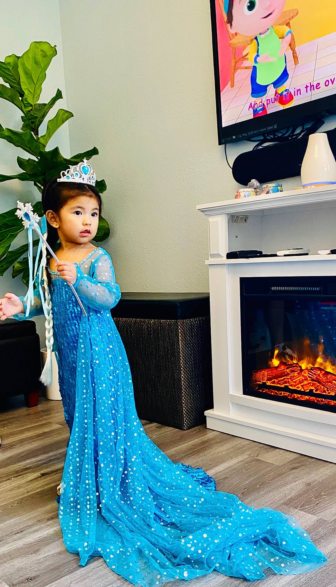 Phillana is registered to the contest to win money with this photo: blue, child, dress, fireplace, flooring, formal_wear, furniture, party, person, room, surprise, toddler, tradition, turquoise