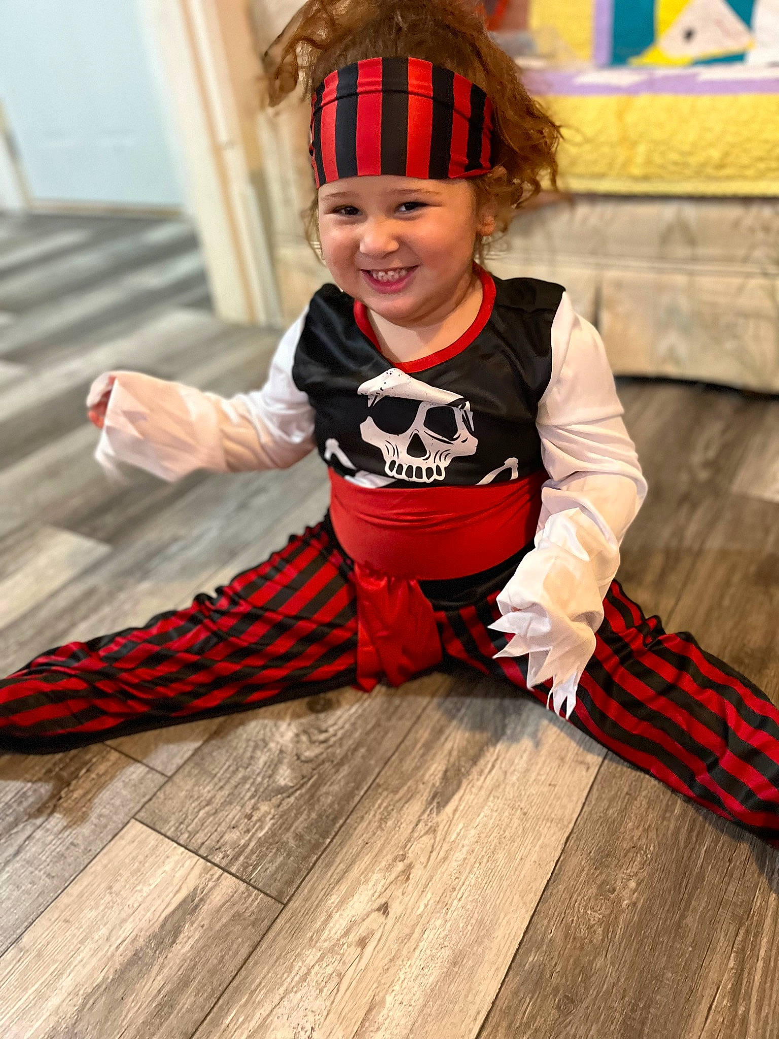 Isabella joined the competition — help win amazing prizes! baby_toddler_clothing, child, costume, costume_hat, event, fashion_accessory, flooring, fun, happy, hardwood, headwear, joy, orange, pattern, person, sitting, sleeve, smile, toddler, varnish
