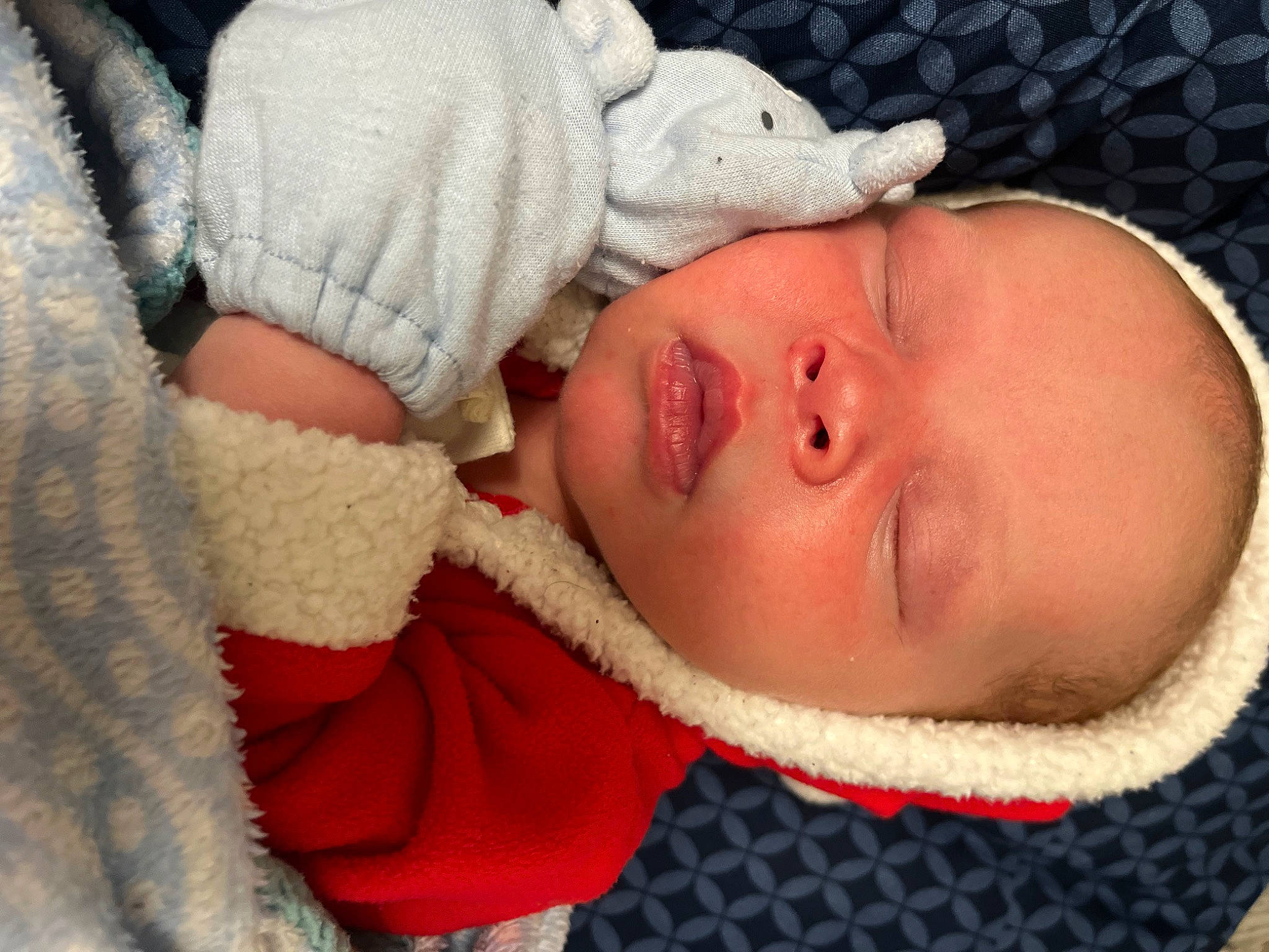 Zakai is registered to the contest to win money with this photo: baby, baby_sleeping, baby_toddler_clothing, cheek, child, chin, close_up, comfort, eye, face, head, human_body, knit_cap, linens, lip, mouth, nose, person, skin, toddler