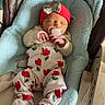 newborn, baby, infant, sleeping, pacifier, headband, bow, red_clothing, tulip_pattern, blanket, baby_seat, soft_fabric, indoor, tile_floor, cute, peaceful, resting, cozy, child, portrait