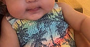 Ivy joined the competition — help win amazing prizes! arm, baby, child, chubby_cheeks, closeup, colorful_clothing, cute, dress, face, hand, hat, holding, indoor, infant, patterned_fabric, person, portrait, smile, toddler, young_child