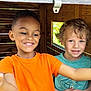 child, children, smiling, happy, playhouse, wood, wooden_structure, orange_shirt, teal_shirt, boy, indoor, natural_light, window, casual_clothing, portrait, friends, cute, fun, together, playtime