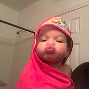 Luna is registered to the contest to win money with this photo: toddler, child, face, pout, pink_towel, bathroom, hooded_towel, cute, expression, indoor, door, vent, skin, person, portrait, young_child, wrapped, soft, playful, funny_face