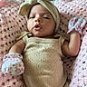 Nova joined the competition — help win amazing prizes! baby, infant, crocheted_blanket, pink, beige_outfit, headwrap, bow, mittens, floral_pattern, soft_texture, cute, lying_down, portrait, closeup, child, newborn, expression, indoor, comfortable, cozy