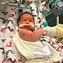Thaddeus is registered to the contest to win money with this photo: newborn, baby, hospital, blanket, footprints, nasal_cannula, medical_equipment, gloved_hand, infant, patient, bed, care, healthcare, tubes, swaddled, resting, cute, child, person, medical