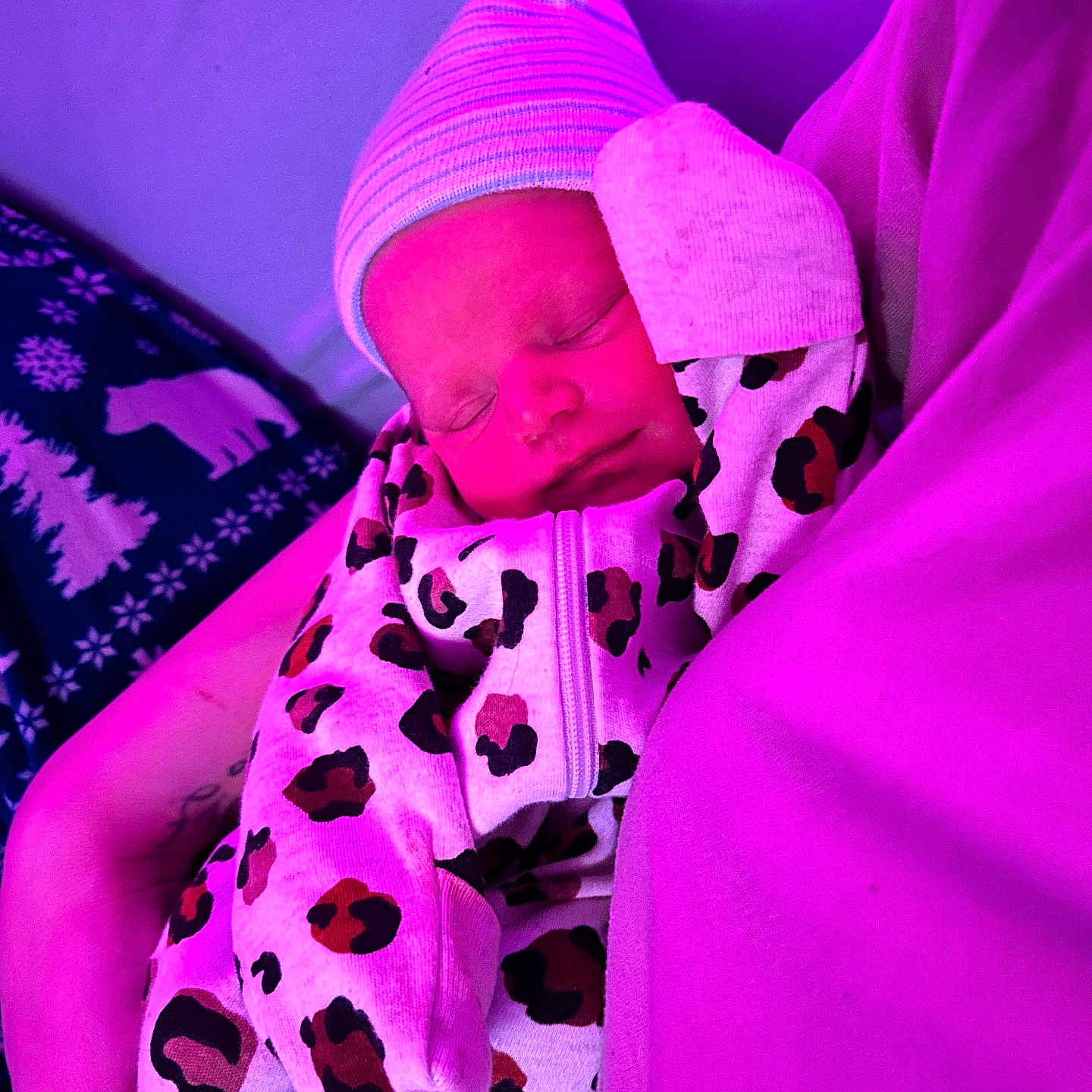Amelia is registered to the contest to win money with this photo: adult, baby, bed, blanket, bonnet, cap, clothing, couch, face, female, furniture, hat, head, newborn, person, photography, portrait, purple, sleeping, woman
