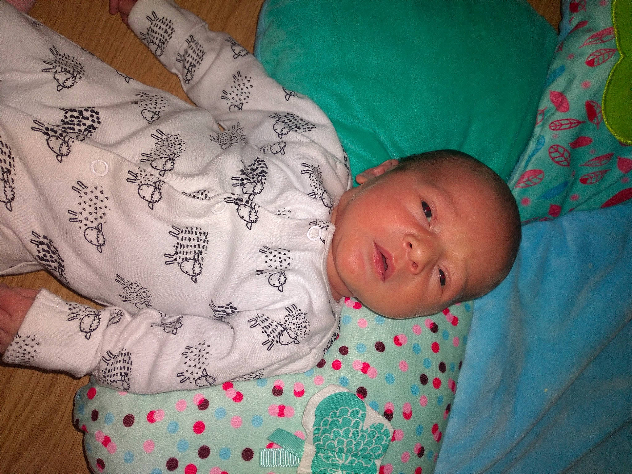 Charlie is registered to the contest to win money with this photo: arm, baby, baby_toddler_clothing, child, clothing, comfort, eye, facial_expression, finger, hand, head, human_body, linens, mammal, pattern, person, product, skin, sleeve, textile