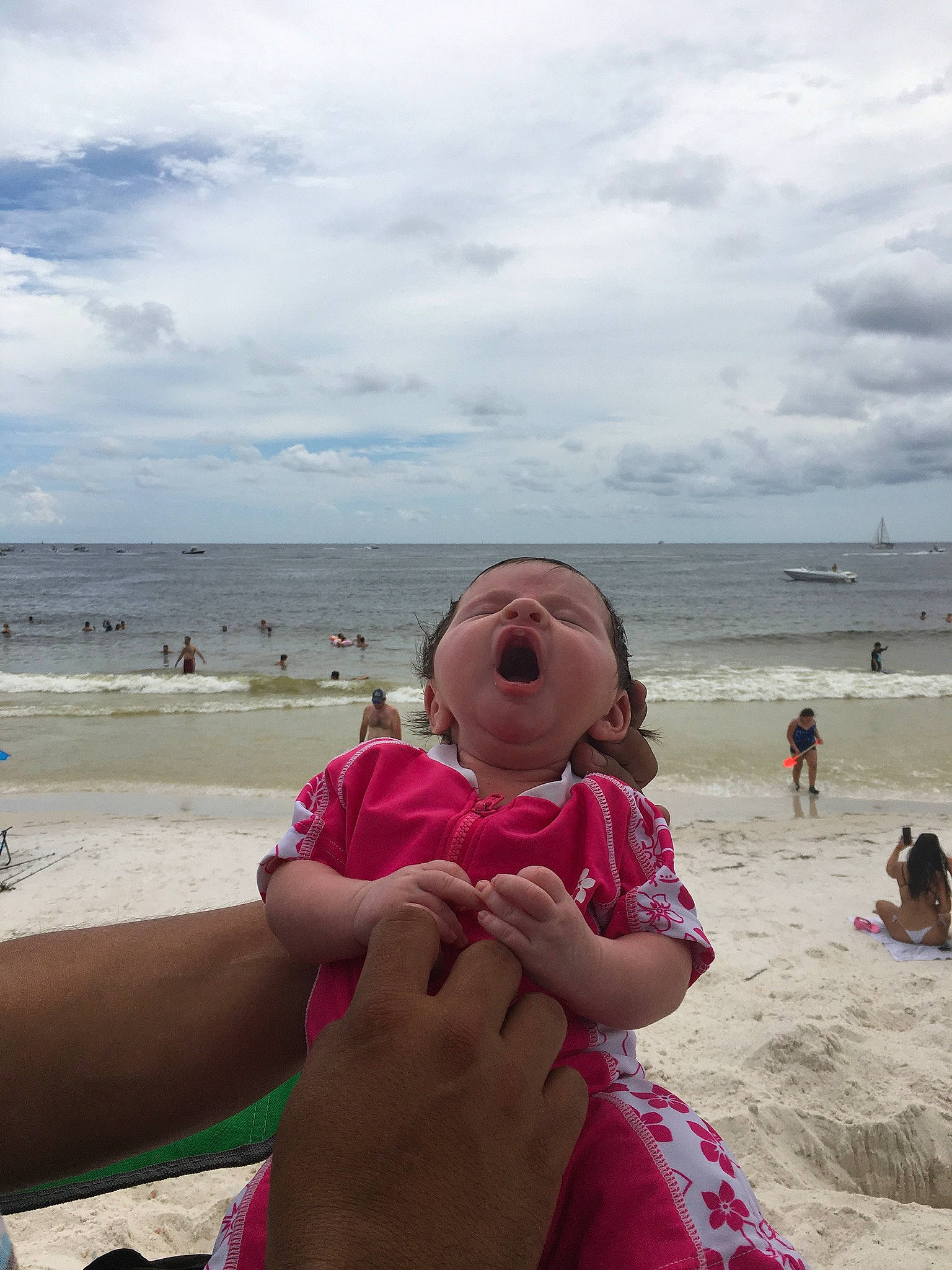 Allyson is registered to the contest to win money with this photo: beach, body_of_water, cloud, coastal_and_oceanic_landforms, foot, fun, gesture, hand, happy, holiday, horizon, leisure, people, people_on_beach, person, sand, sky, summer, thigh, travel