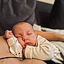 Amelie joined the competition — help win amazing prizes! baby, sleeping, infant, onesie, cuddling, peaceful, face, hand, soft, closeup, child, resting, cozy, nap, skin, person, indoors, comfort, cute, portrait