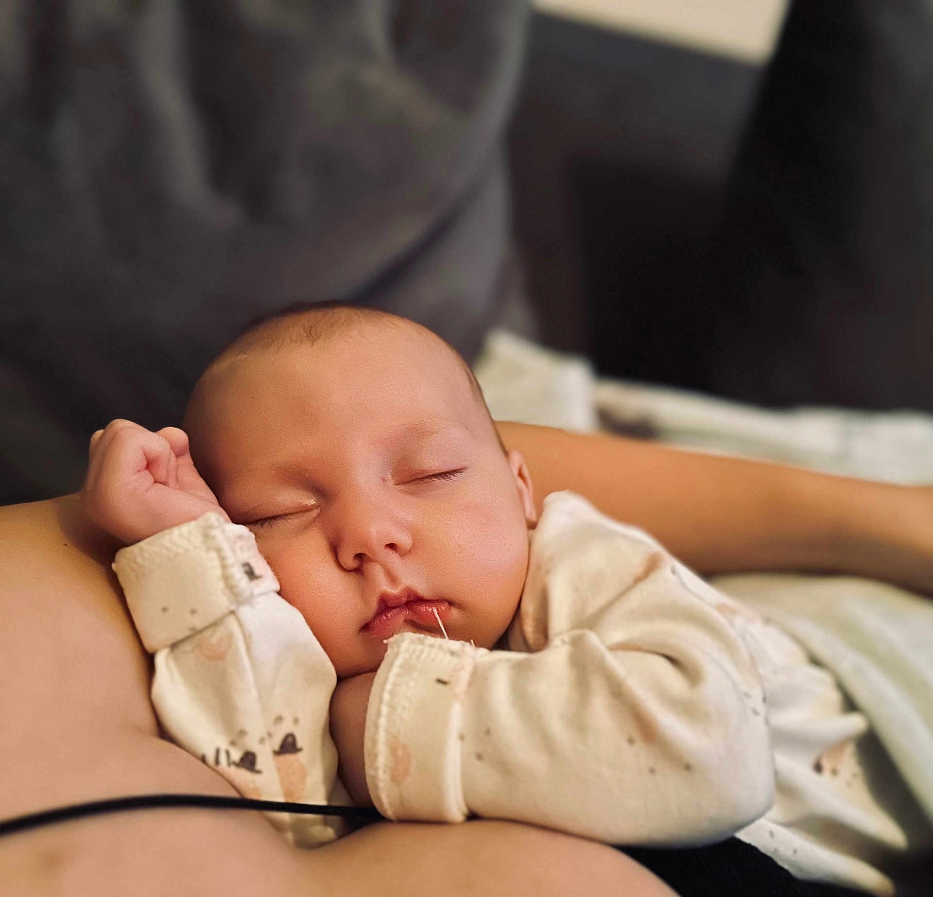 Amelie joined the competition — help win amazing prizes! baby, sleeping, infant, onesie, cuddling, peaceful, face, hand, soft, closeup, child, resting, cozy, nap, skin, person, indoors, comfort, cute, portrait