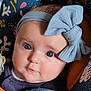 baby, blue_eyes, bow, carrier, child, close_up, clothing, cute, expression, face, head, headband, indoors, infant, patterned_fabric, portrait, seat_belt, skin, soft_lighting, young_child