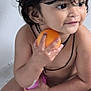 toddler, child, bathtub, water, bubbles, orange, toy, wet_hair, smiling, skin, earrings, black_string, bath_time, cute, happy, young_child, indoor, play, sitting, person
