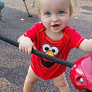 Seth is registered to the contest to win money with this photo: toddler, child, playground, rope, red_clothing, elmo, shoes, outdoor, toy, happy, smiling, blue_eyes, short_hair, play, daylight, park, fun, person, standing, grip