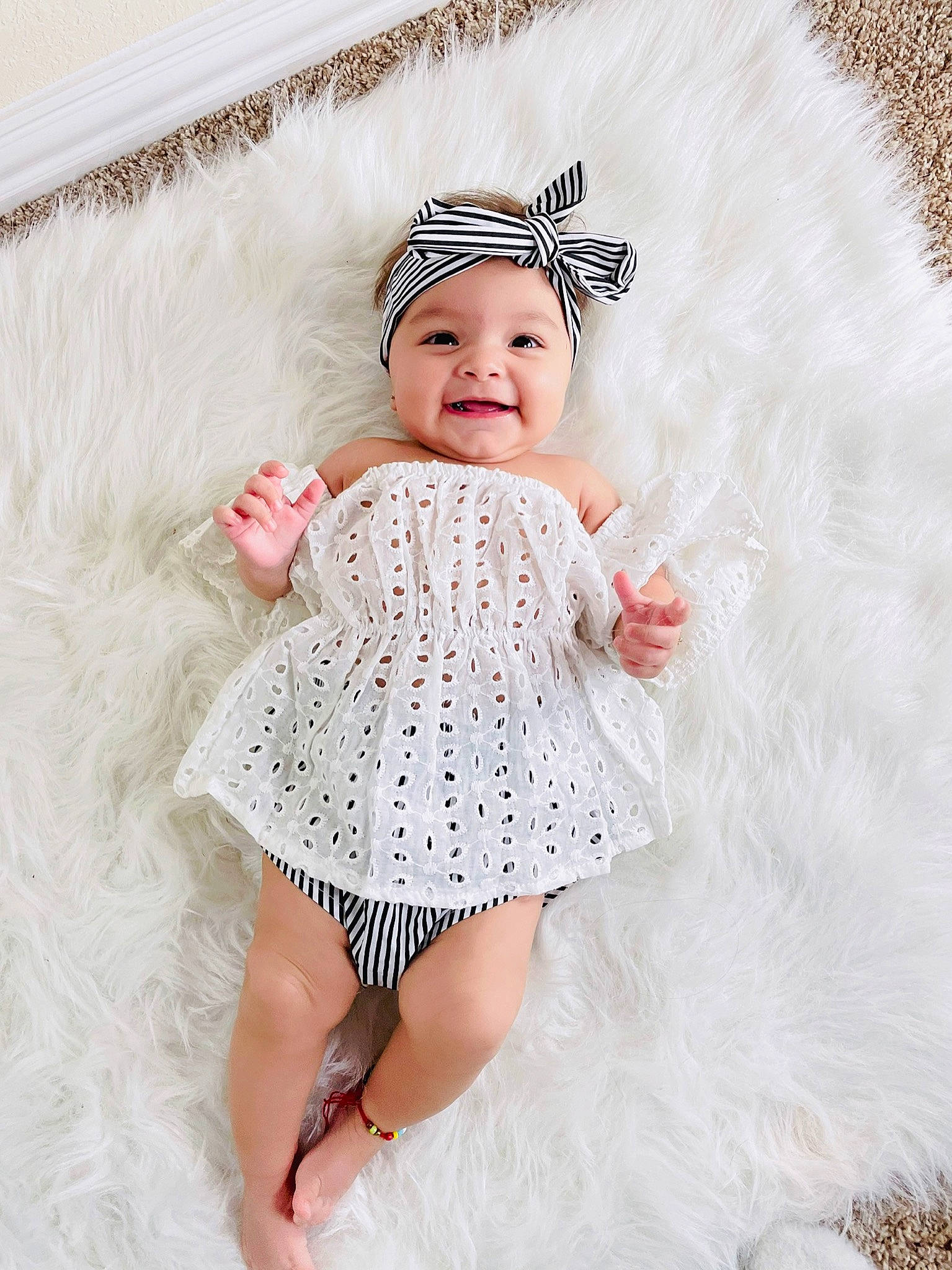 Isabella is registered to the contest to win money with this photo: baby, baby_toddler_clothing, day_dress, dress, embellishment, face, hair_accessory, happy, headgear, headpiece, headwear, iris, joy, mythical_creature, one_piece_garment, pattern, person, pink, ruffle, sleeve