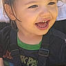 child, toddler, smiling, happy, laughing, portrait, face, eyes, hair, seated, car_seat, safety_harness, blanket, shirt, clothing, indoor, close_up, photograph, screenshot, joy