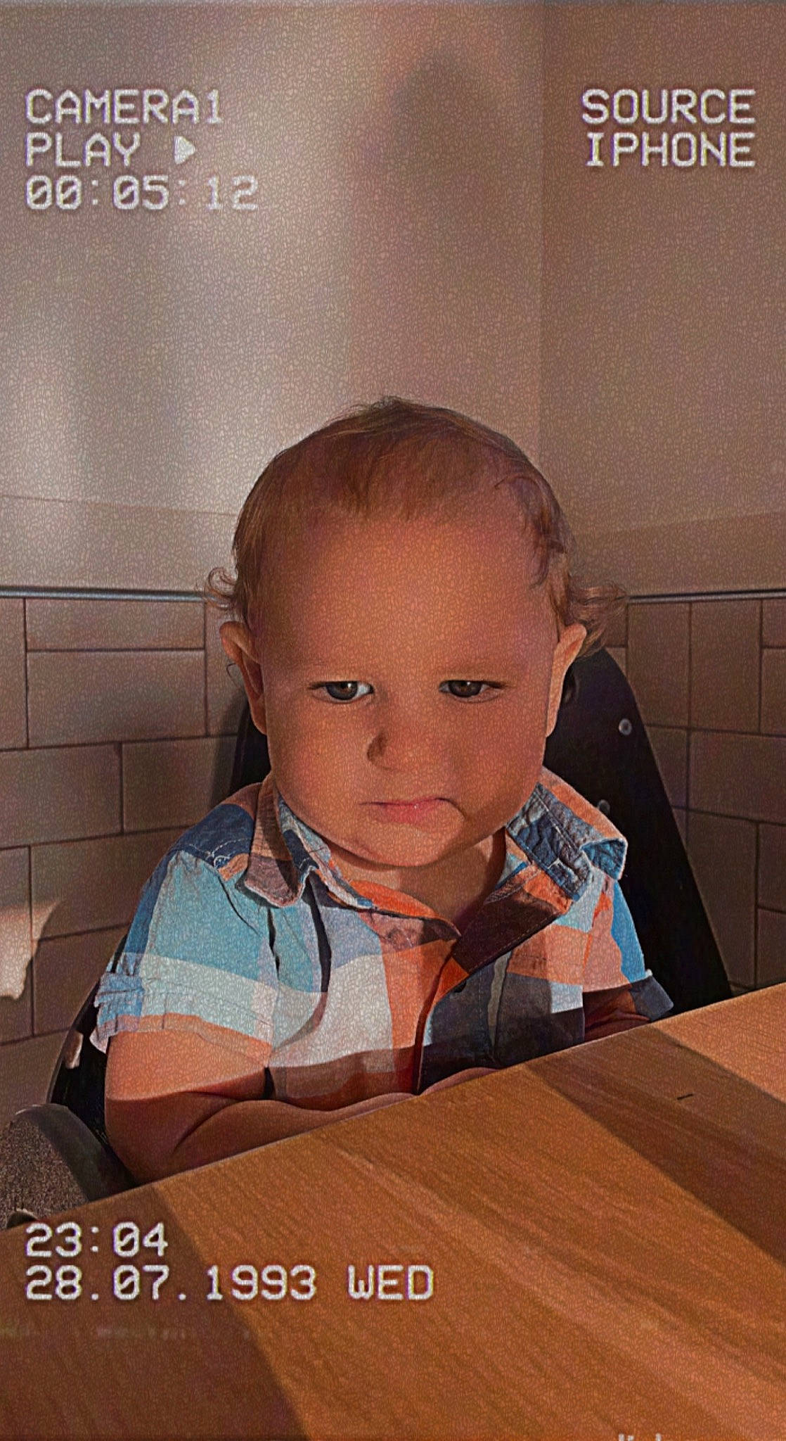 Jaxon is registered to the contest to win money with this photo: baby, baby_toddler_clothing, child, eye, eyebrow, flooring, happy, hardwood, nose, person, photo_caption, room, sitting, skin, sleeve, t_shirt, table, toddler, varnish, wood