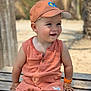 toddler, child, smiling, outdoor, bench, cap, orange_clothing, shorts, sleeveless, sunny, daylight, palm_trees, nature, skin, happy, portrait, sitting, baby, cute, summer