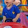 Simon a rejoint le concours — aidez-le/la à gagner de superbes lots ! child, toddler, blue_jersey, ride_on_car, red_car, steering_wheel, smiling, outdoor, playground, toy, happy, person, short_hair, daylight, amusement_park, cartoon_character, background_blur, casual_clothing, fun, young_child