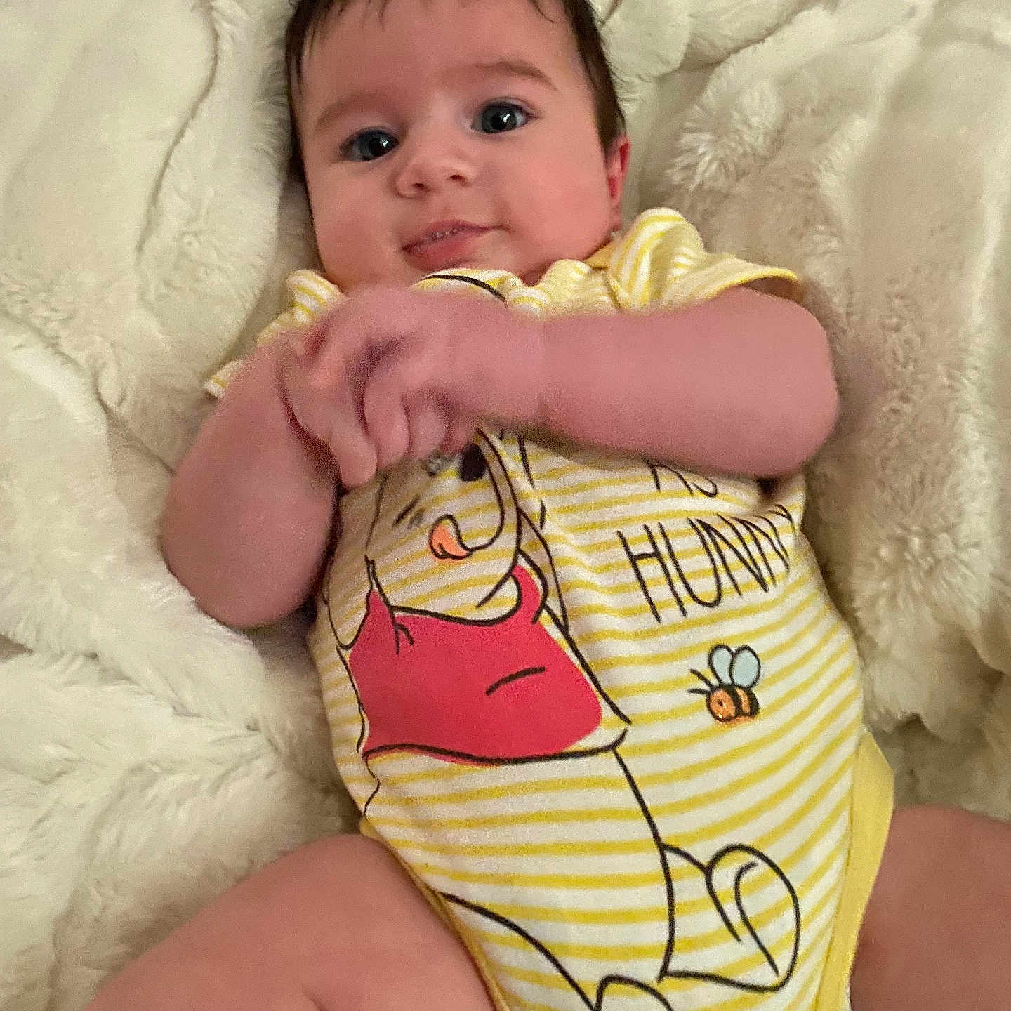 Bellamy is registered to the contest to win money with this photo: baby, biting, blanket, bodypart, clothing, couch, face, finger, furniture, hand, happy, head, newborn, person, photography, portrait, quilt, sitting, smile, t_shirt