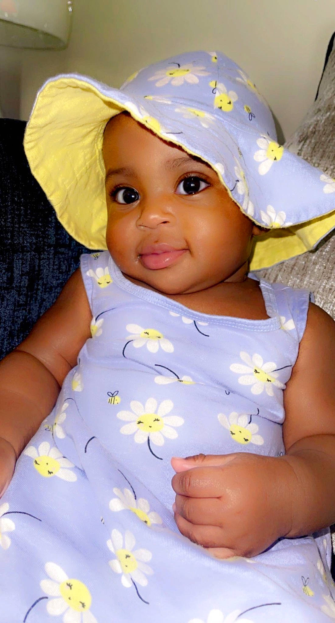 My'Lani is registered to the contest to win money with this photo: baby, baby_toddler_clothing, blue, cap, chin, eye, face, facial_expression, finger, gesture, happy, hat, headwear, lip, person, photograph, skin, sleeve, smile, sun_hat